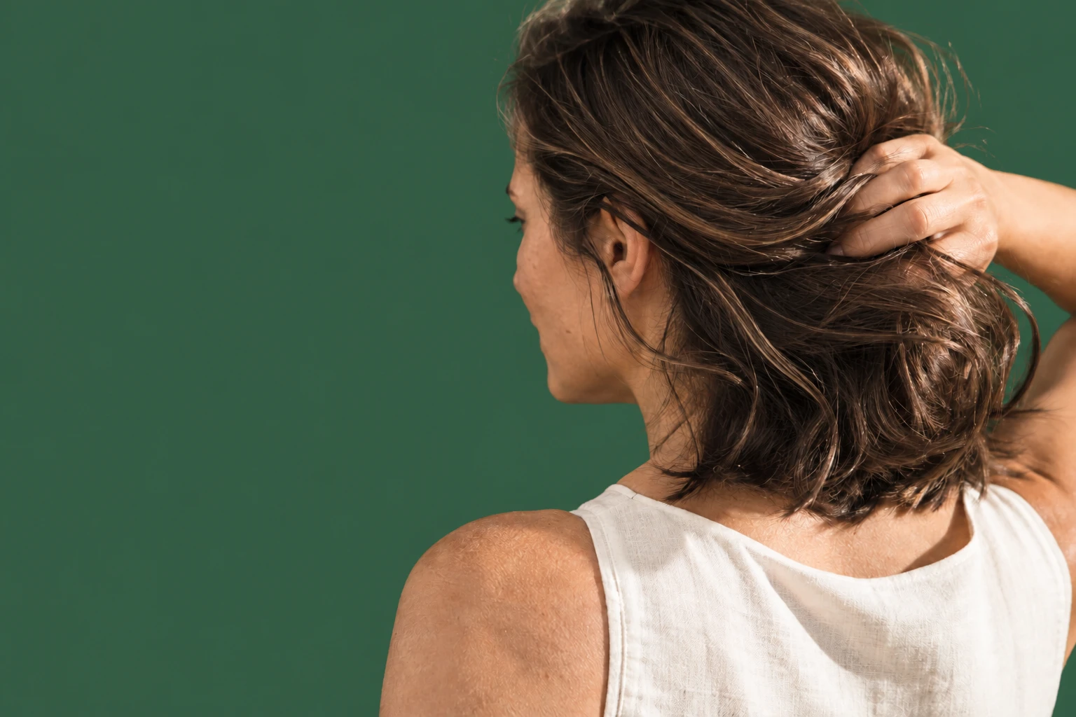 Woman lifting her hair